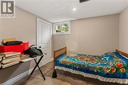 Wood-finish flooring, recessed lighting, and a white interior door - 