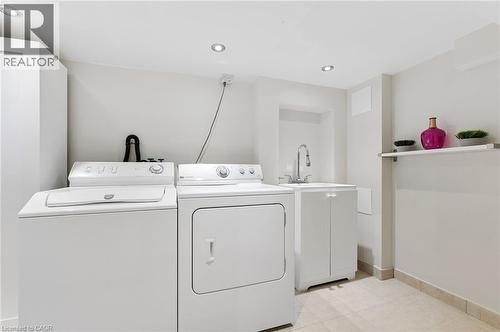 Recessed ceiling lighting, tiled flooring, built-in shelving, utility sink, and built-in cabinetry - 164 Wilson Street, Hamilton, ON 