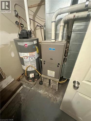 Vertical tank water heater and forced-air furnace unit with metal ductwork - 150 Princess Street, Hamilton, ON 