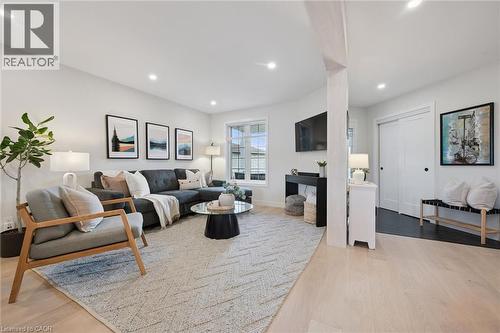 Recessed lighting illuminates the living space featuring light wood-finish flooring - 6 Branwood Place, Kitchener, ON 