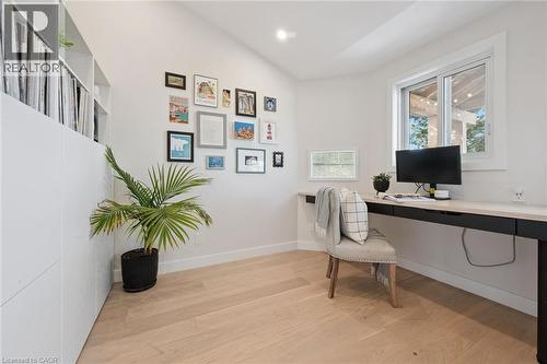 Light wood-finish flooring, shelving, vaulted ceiling, recessed lighting, and a built-in desk - 6 Branwood Place, Kitchener, ON 
