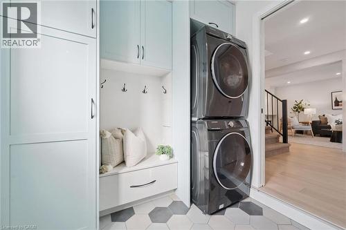 Built-in cabinetry, mudroom bench with storage, and integrated coat hooks. Stackable laundry. - 6 Branwood Place, Kitchener, ON 