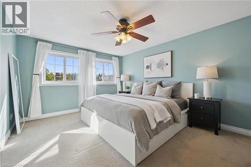Recessed windows with grid patterns, ceiling fan, light-toned carpet - 6 Branwood Place, Kitchener, ON 