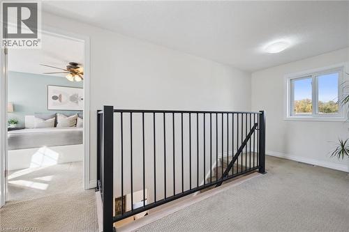 Carpeted landing with black metal railing - 6 Branwood Place, Kitchener, ON 