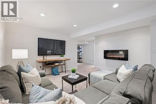 Recessed lighting, wall-mounted electric fireplace, light-toned carpeting - 6 Branwood Place, Kitchener, ON 