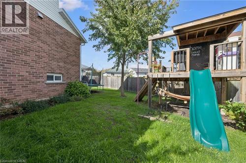 Expansive grassy yard with a brick exterior, mature tree, and fencing - 6 Branwood Place, Kitchener, ON 