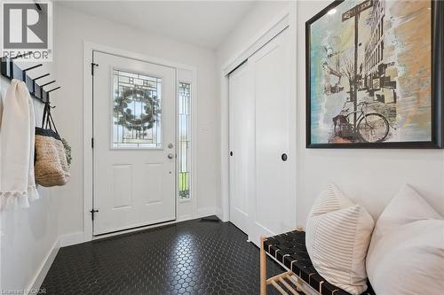 Entryway featuring black hexagonal tile flooring, a white paneled entry door with decorative glass, and a vertical glass sidelight - 6 Branwood Place, Kitchener, ON 