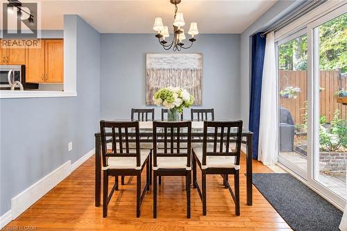 Wood-finish flooring with a partial wall opening to an additional room - 327 Oprington Place, Kitchener, ON 
