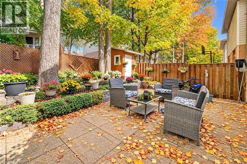 Expansive patio area featuring paving stones and a privacy fence - 327 Oprington Place, Kitchener, ON 