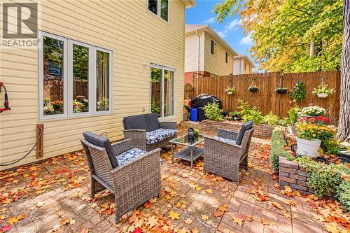 Brick paver patio with a surrounding privacy fence and raised garden beds - 327 Oprington Place, Kitchener, ON 