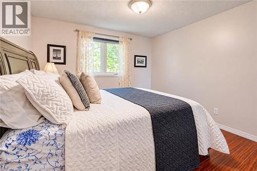 Wood-finish flooring, white walls, and a window with white trim - 327 Oprington Place, Kitchener, ON 