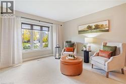 Large picture window with transom detailing, neutral wall tones, and wall-to-wall carpeting - 