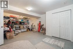 Interior room featuring white walls, neutral floor surfacing, built-in open wire shelving, and a double-door closet - 