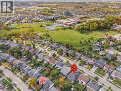 Aerial perspective of a detached residential property featuring a pitched roof, rear yard, and proximity to expansive green space and public recreation areas - 