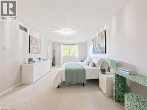 Neutral-toned carpeted flooring, textured ceiling, flush-mount decorative ceiling light fixture, and window with white trim - 488 Heather Hill Place, Waterloo, ON 