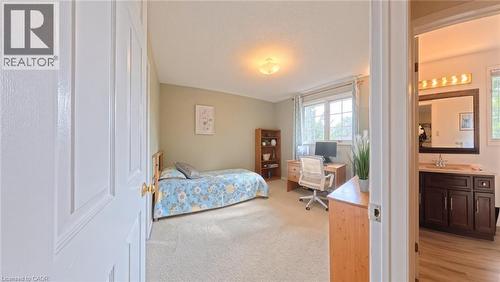 Neutral-toned bedroom featuring carpeted flooring and a window with natural light - 488 Heather Hill Place, Waterloo, ON 