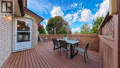 Raised wood deck featuring a lattice-topped privacy fence and exterior wall-mounted lighting - 488 Heather Hill Place, Waterloo, ON 