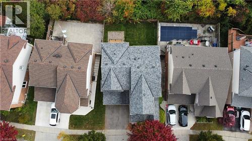 Aerial perspective of a detached residential property featuring a multi-gabled asphalt shingle roof, a paved driveway, and a fenced rear yard with a patio - 83 Glazebrook Crescent, Cambridge, ON 