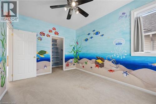 Neutral carpeting, white six-panel interior door, multi-tier closet shelving, and a ceiling-mounted light fixture with a fan - 83 Glazebrook Crescent, Cambridge, ON 