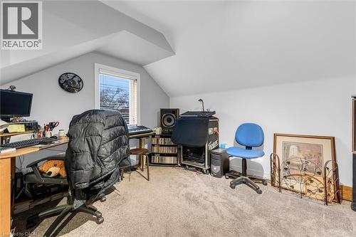 Vaulted ceiling with sloped walls, neutral carpeting, and a recessed window - 143 Walter Avenue S, Hamilton, ON 