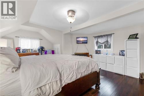 Vaulted ceiling with a central flush-mount light fixture and dark wood-finish flooring - 143 Walter Avenue S, Hamilton, ON 