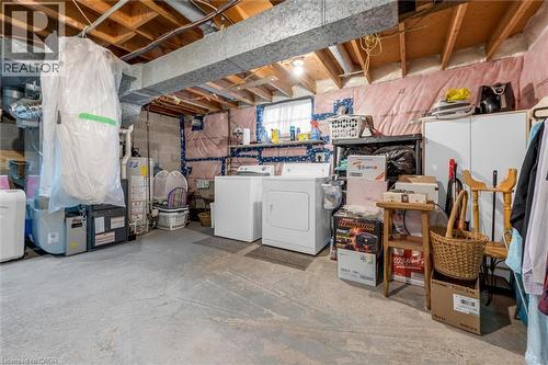 Unfinished utility area featuring exposed joists, concrete flooring, concrete masonry unit walls with insulation, and a single-pane window - 143 Walter Avenue S, Hamilton, ON 