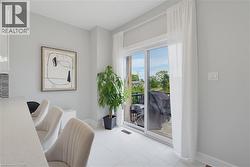 Sliding glass door with exterior access, large-format tile flooring, and quartz-finish countertop - 