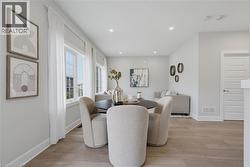 Open floor plan featuring wood-finish flooring, recessed lighting, and expansive windows - 