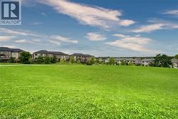 Expansive green lawn featuring mature trees and open space - 