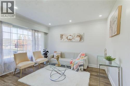 Large multi-pane window, wood-finish flooring, and recessed ceiling lighting - 46 Traynor Avenue, Kitchener, ON 