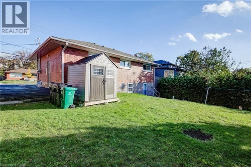 Red brick exterior featuring a multi-paneled gable roof and a private fenced yard area - 46 Traynor Avenue, Kitchener, ON 