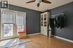 Wood-finish flooring, ceiling fan, and French doors with integrated blinds - 
