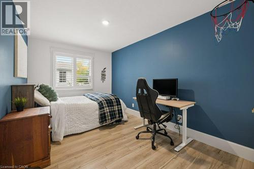Room featuring wood-finish flooring, recessed lighting, and interior window shutters - 361 Lee Circle, Waterloo, ON 