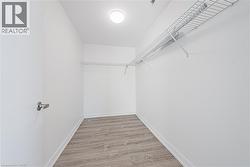 Recessed overhead lighting, wood-finish flooring, and wire shelving - 