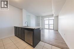 Kitchen island with a stainless steel sink, gooseneck faucet, and integrated dishwasher - 