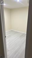 Interior room featuring neutral wall paint, wood-finish flooring, and recessed ceiling lighting - 