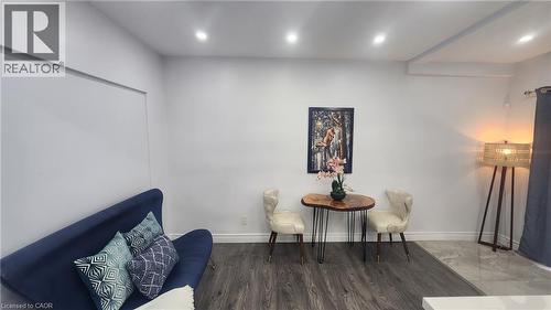 Neutral wall color, wood-finish flooring, and recessed ceiling lighting - 1394 Cannon Street E, Hamilton, ON 