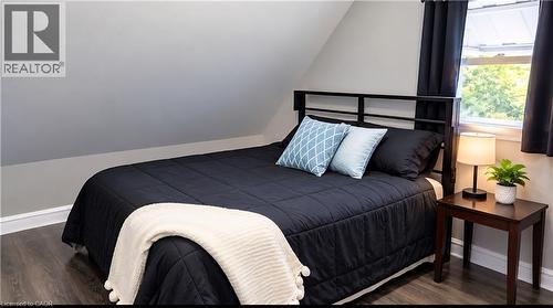 Vaulted ceiling, neutral wall tones, and wood-finish flooring - 1394 Cannon Street E, Hamilton, ON 