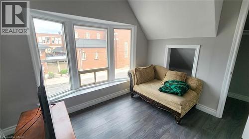 Large bay window featuring multi-pane glass, wood-finish flooring, vaulted ceiling, and built-in wall niche - 1394 Cannon Street E, Hamilton, ON 