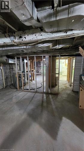 Unfinished lower level featuring concrete flooring, exposed wooden wall framing, and exposed HVAC ductwork - 1394 Cannon Street E, Hamilton, ON 