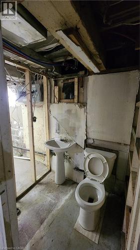 Pedestal sink with faucet and porcelain toilet fixture - 1394 Cannon Street E, Hamilton, ON 