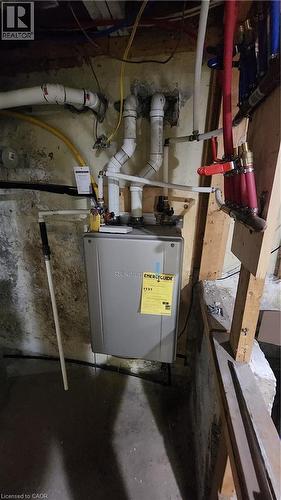 Wall-mounted tankless water heater featuring PEX manifold plumbing distribution and PVC venting - 1394 Cannon Street E, Hamilton, ON 
