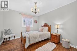 Wood-finish flooring, neutral wall tones, and a traditional four-light chandelier - 