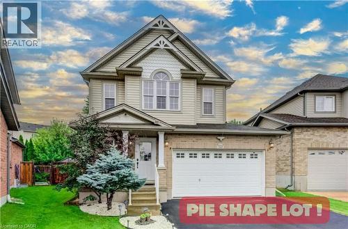 Two-story residence featuring a combination brick and vinyl siding exterior, an arched window detail, decorative gable accents, and an attached two-car garage - 521 Snowdrop Court, Kitchener, ON 