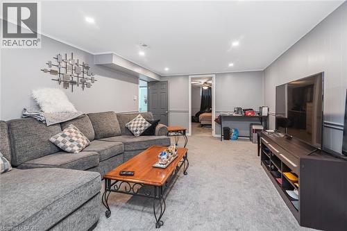 Neutral-toned interior featuring recessed lighting, wall molding, and plush carpeting - 43 Alderney Avenue, Hamilton, ON 