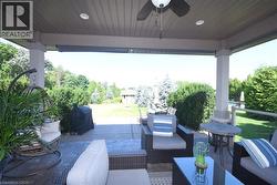 Covered patio with recessed lighting, ceiling fan, and support columns - 