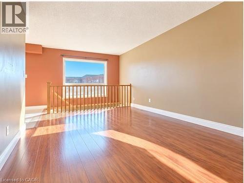 Wood-finish flooring, natural light, and a wooden balustrade - 52 Isabella Street, Kitchener, ON 