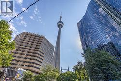 Urban setting featuring glass-curtain wall architecture, high-rise buildings, and proximity to the CN Tower - 