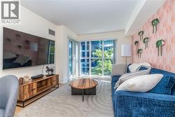 Floor-to-ceiling windows, wall-to-wall decorative patterned wall covering, and neutral-toned wall paint - 