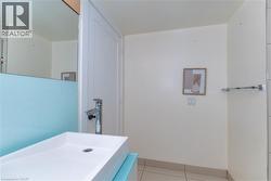 Floating vanity with a rectangular basin, chrome single-handle faucet, large wall mirror, and metal towel bar - 